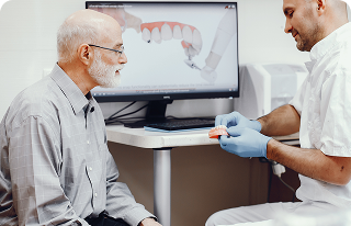 Dentist showing dental model to patient